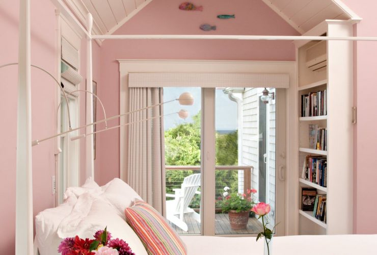 a bedroom with a white bed, pink walls and a matching sloping ceiling is such a cozy sleeping space