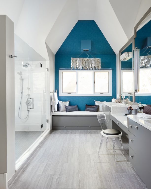 a blue wall and gray cabinets are perfect for a glamour transitional bathroom