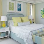 a sapphire bed with a stone headboard combine seamlessly with yellow bedside lamps