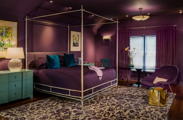 a trendy master bedroom with darker purple and teal shades