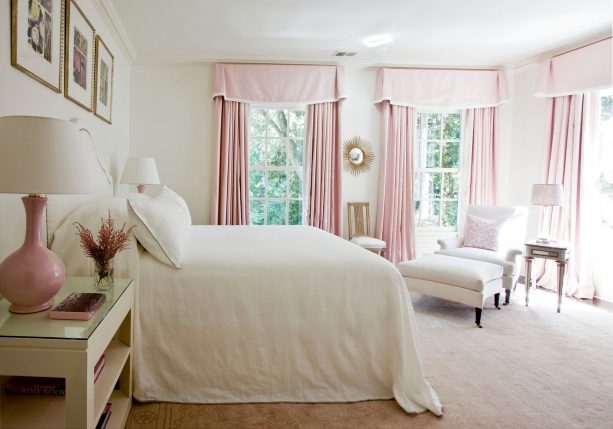 pink curtains and bedside table lamps make a cute bedroom