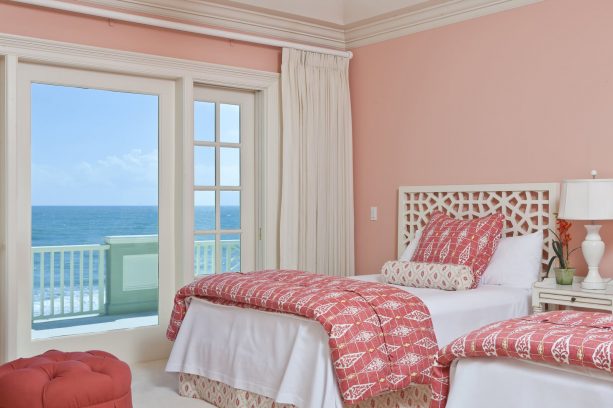 soft pink walls and pink bedding combine seamlessly with a white floor and bed