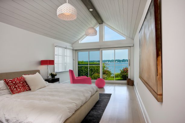 white walls, white bedding, and pink furniture are great for a bright beach style bedroom
