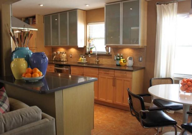 after remodel raised ranch kitchen with glass and brushed-steel cabinet doors