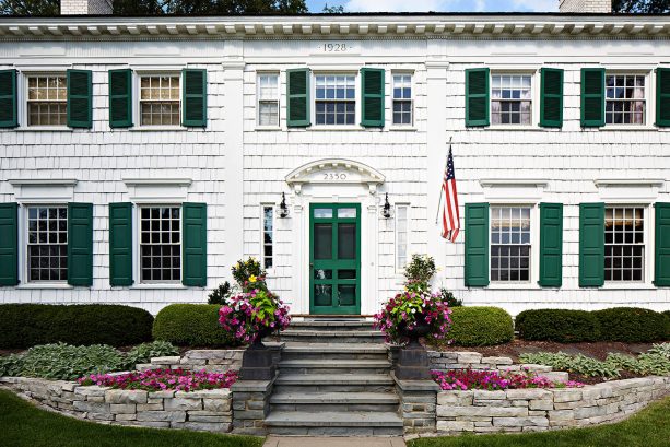 an elegant white house needs darker green shutters more than anything