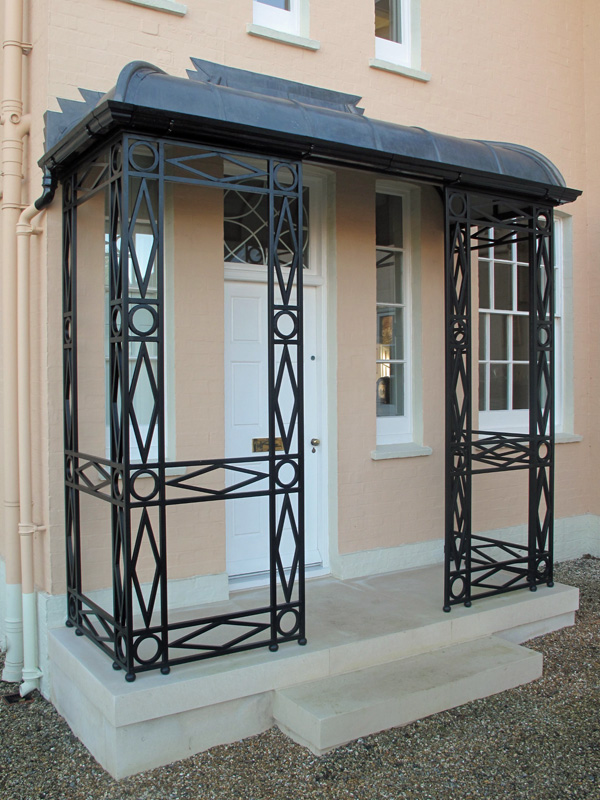 bold decorative wrought iron columns for a clean porch