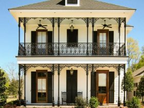 lanky wrought iron columns add a pleasant look to the porch of a two-story house