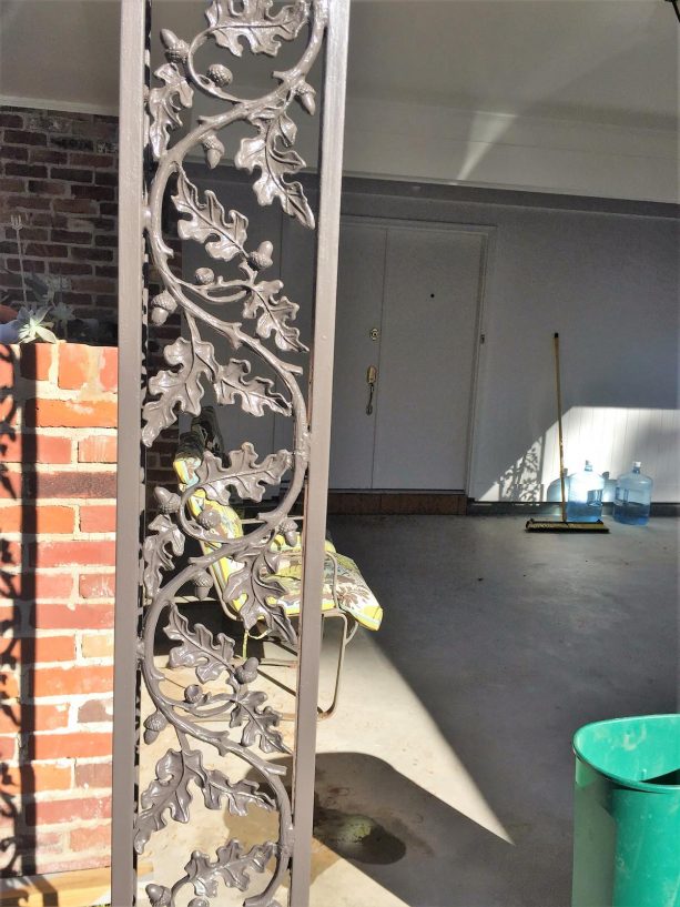 wrought iron columns that offer iron leaves are cool additions to a contemporary porch