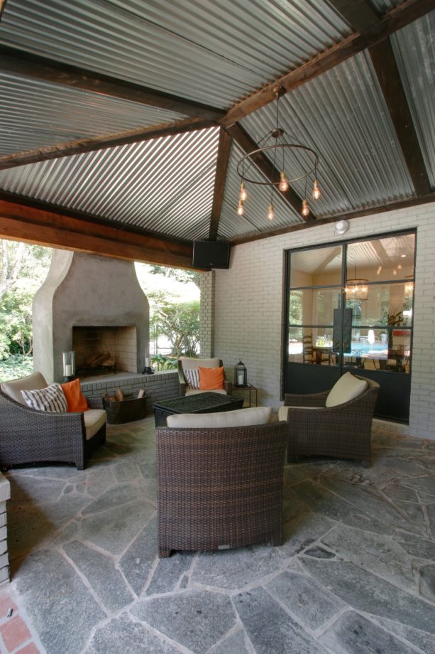 a contemporary corrugated metal roof patio cover supported by wood beams