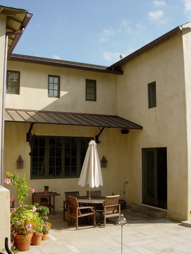 a down to earth copper awning design for a tuscan patio