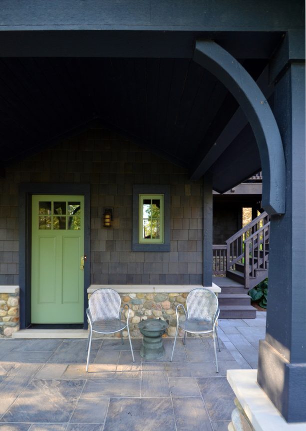 a green door on a gray craftsman entry provides a pretty colored pop