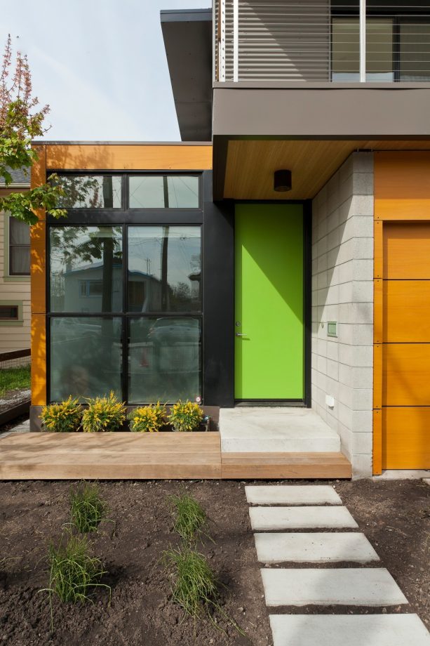 a green front door is painted in behr limeade s-g-420 that never fails to mix with its surroundings