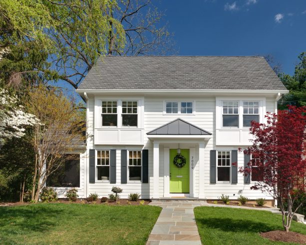 a sherwin williams’ center stage green front door and a white exterior make a clean, crisp, and timeless appearance