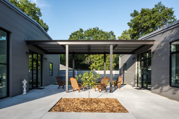 a steel roof patio cover design on a side yard patio connecting two buildings