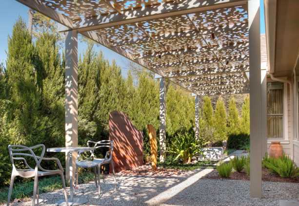 an aluminum ¼” plate patio cover was guarding a small gravel patio