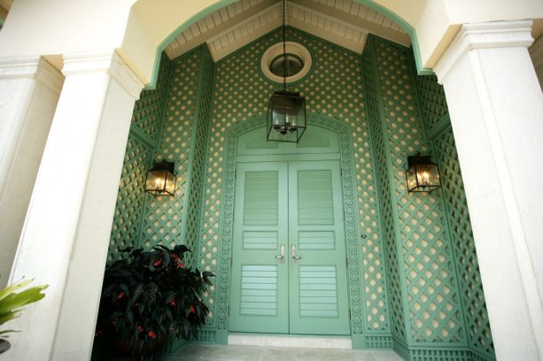 apple-green front doors that contrast against cream