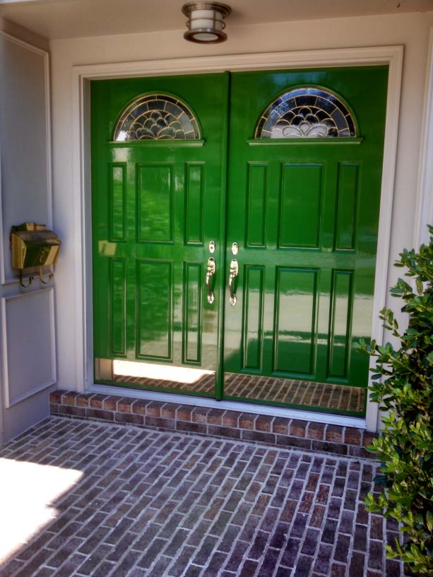 large green front doors with an opening underneath