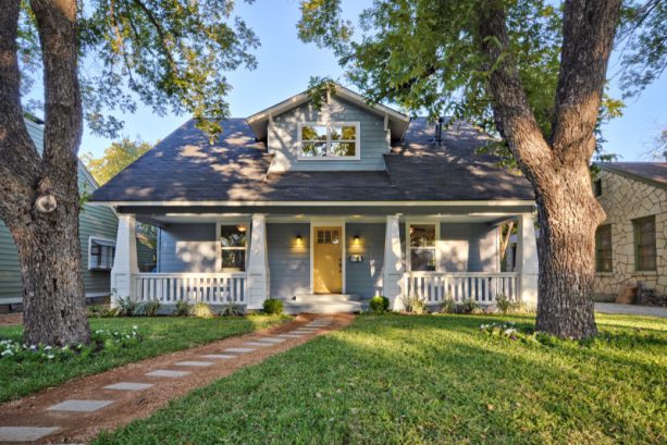 a remodeled craftsman house with a benjamin moore van courtland blue siding and a benjamin moore york harbor yellow door