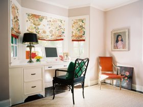 a white built-in wooden bay window desk paired with a black study chair