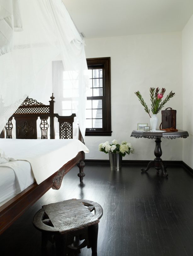 benjamin moore’s night shade trims darker than benjamin moore’s super white walls for an elegant mediterranean bedroom