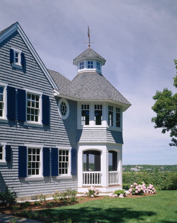 classic two-story house with bm moor glo #096 navy blue shutter paint color and white cedar shingles