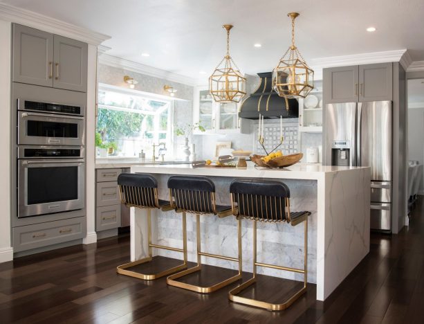 gray floor to ceiling cabinets and glass-front cabinetry in white are perfect for a well-lit kitchen with a big window