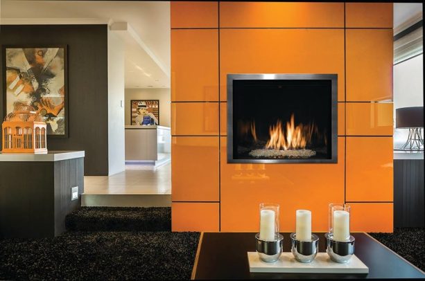 marvelous is an adjective that suits a living room with a bright and shiny orange fireplace and grey walls accompanied by a matching carpet
