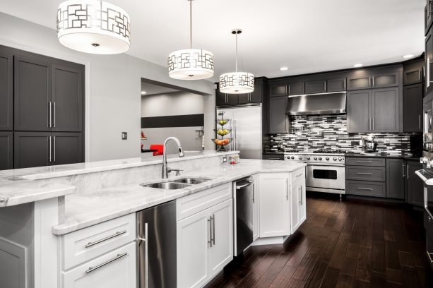 sophisticated looks are easy to achieve when you have gray and white shaker cabinets and a multicolored backsplash in the same kitchen