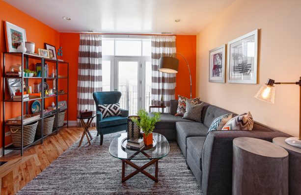 what one needs to create a stunning contemporary living room are orange walls and a big grey sectional sofa with a matching area rug