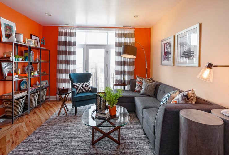 what one needs to create a stunning contemporary living room are orange walls and a big grey sectional sofa with a matching area rug
