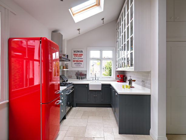 you’ll be able to create an otherworldly striking kitchen by combining gray and white cabinets and a bright red freezer