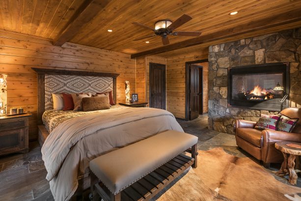 a brown all cedar bedroom with a grey slate floor