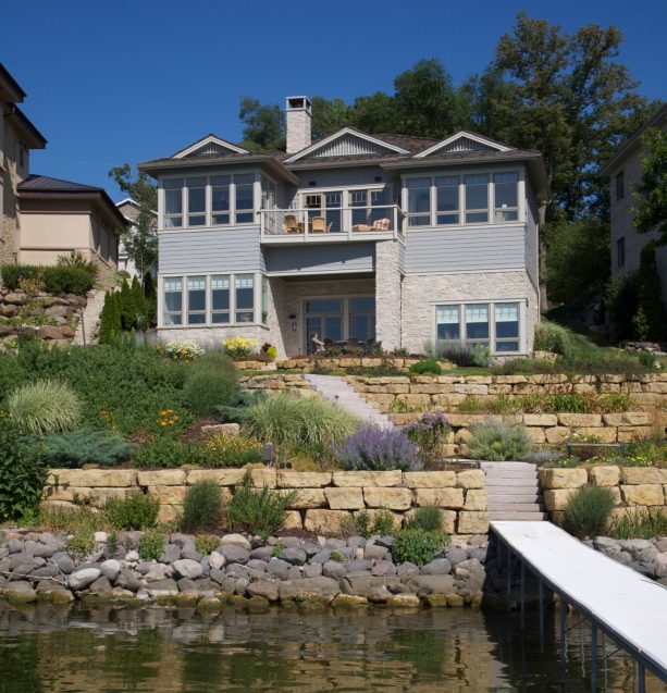 a classic home with rain gardens benefits a lot from the creation of a rip rap retaining wall