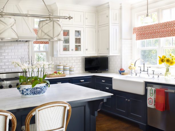 a kitchen with matching navy base cabinets with white marble countertops