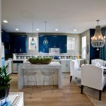 a kitchen with sherwin williams commodore navy wall cabinetry and white dining wing chairs
