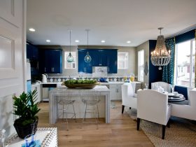 a kitchen with sherwin williams commodore navy wall cabinetry and white dining wing chairs