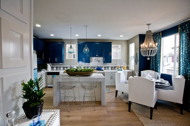 a kitchen with sherwin williams commodore navy wall cabinetry and white dining wing chairs