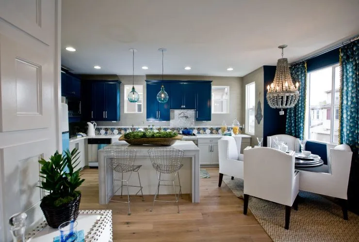 a kitchen with sherwin williams commodore navy wall cabinetry and white dining wing chairs