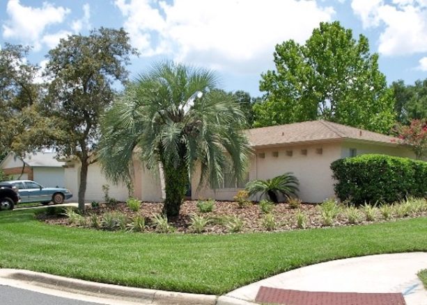 a landscaping idea that turns a corner lot into a formal garden