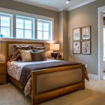 a light brown wooden bed in a bedroom with sherwin williams’ loggia grey walls