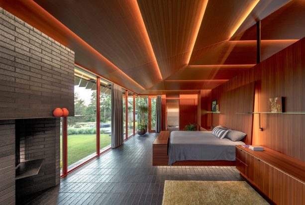 a magnificent bedroom with a brown fir ceiling and a grey tiled floor