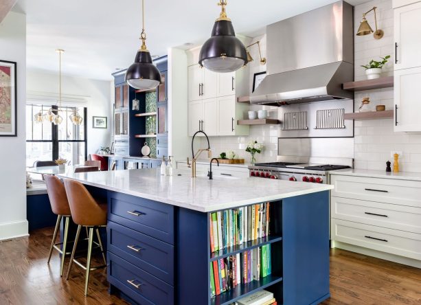 a navy island with bookshelves painted to match sherwin williams naval in a kitchen with white cabinetry