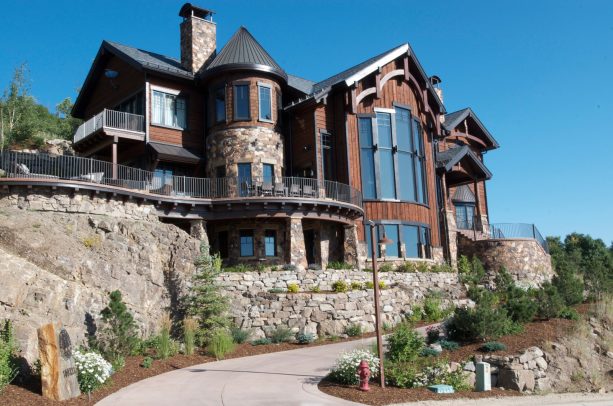 a rip rap retaining wall is an appropriate addition to a mountain-style rustic exterior