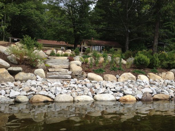 a rip rap retaining wall with granite steps on a lakeside blends function and beauty