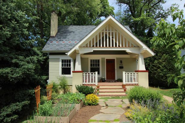 a unique white wooden gable front porch that’s not completely covered