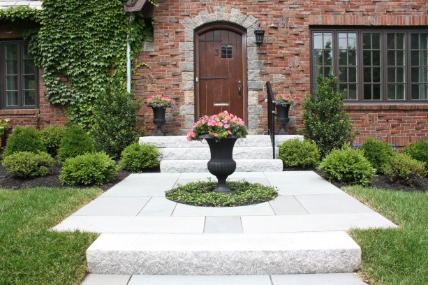 arched wood colonial front door with a tiny grid of glass panels