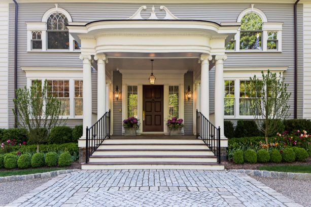 combination of the dark colonial front door and bright sidelight