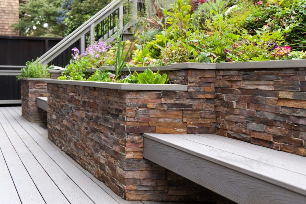 contemporary style stone veneer retaining wall with built-in benches