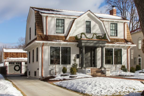 grey recessed panel colonial front door that matches the pillars and the trim