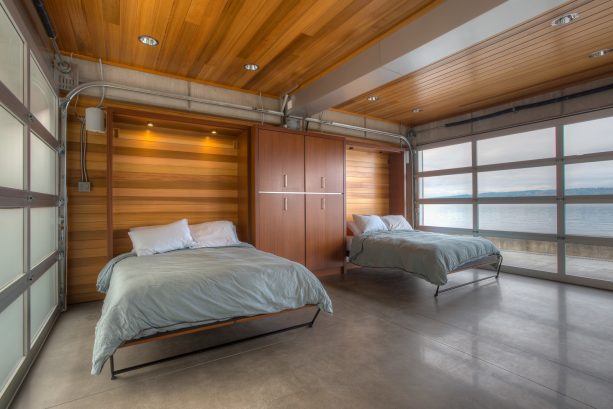 murphy beds with grey bedding are excellent furniture pieces for a bedroom with wooden ceilings and walls